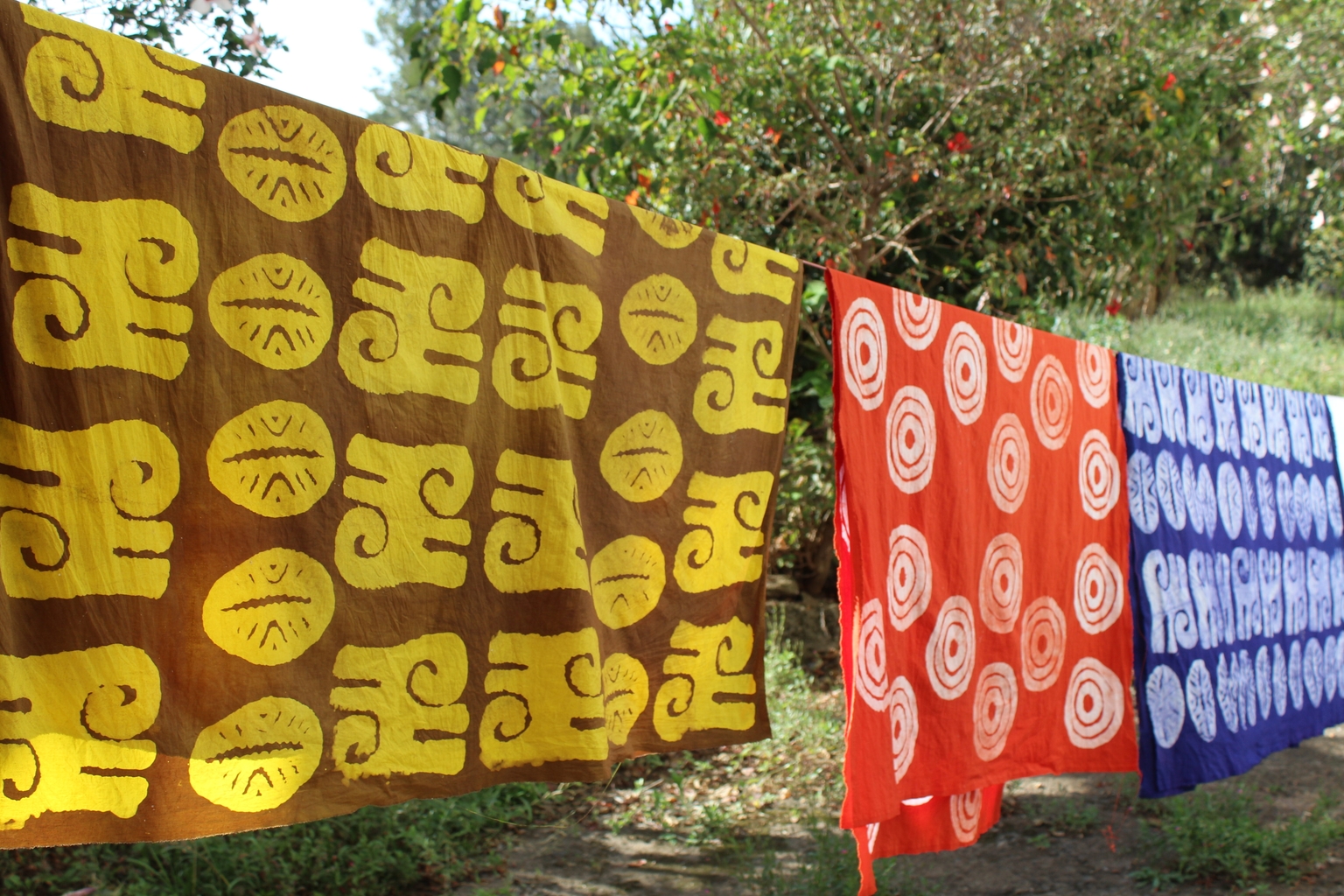 A batik maker working on a finished patterned cloth