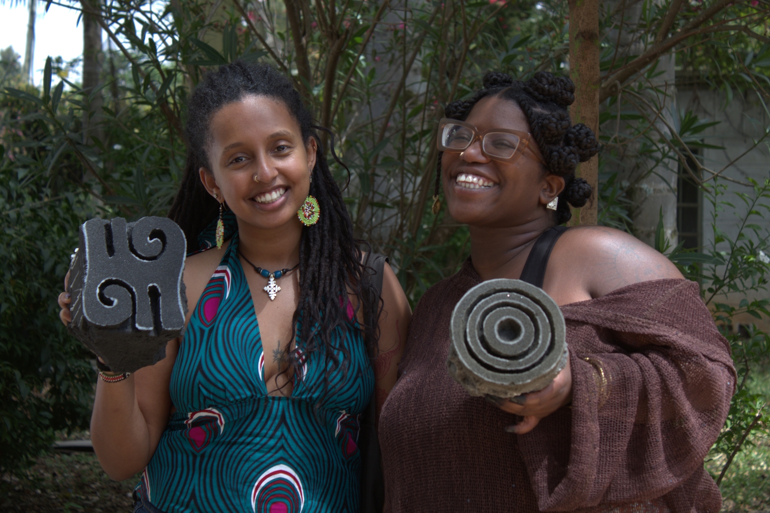 Two participants holding finished batik cloth together